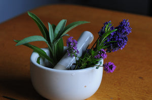 herbs and flowers in a mortar and pestle